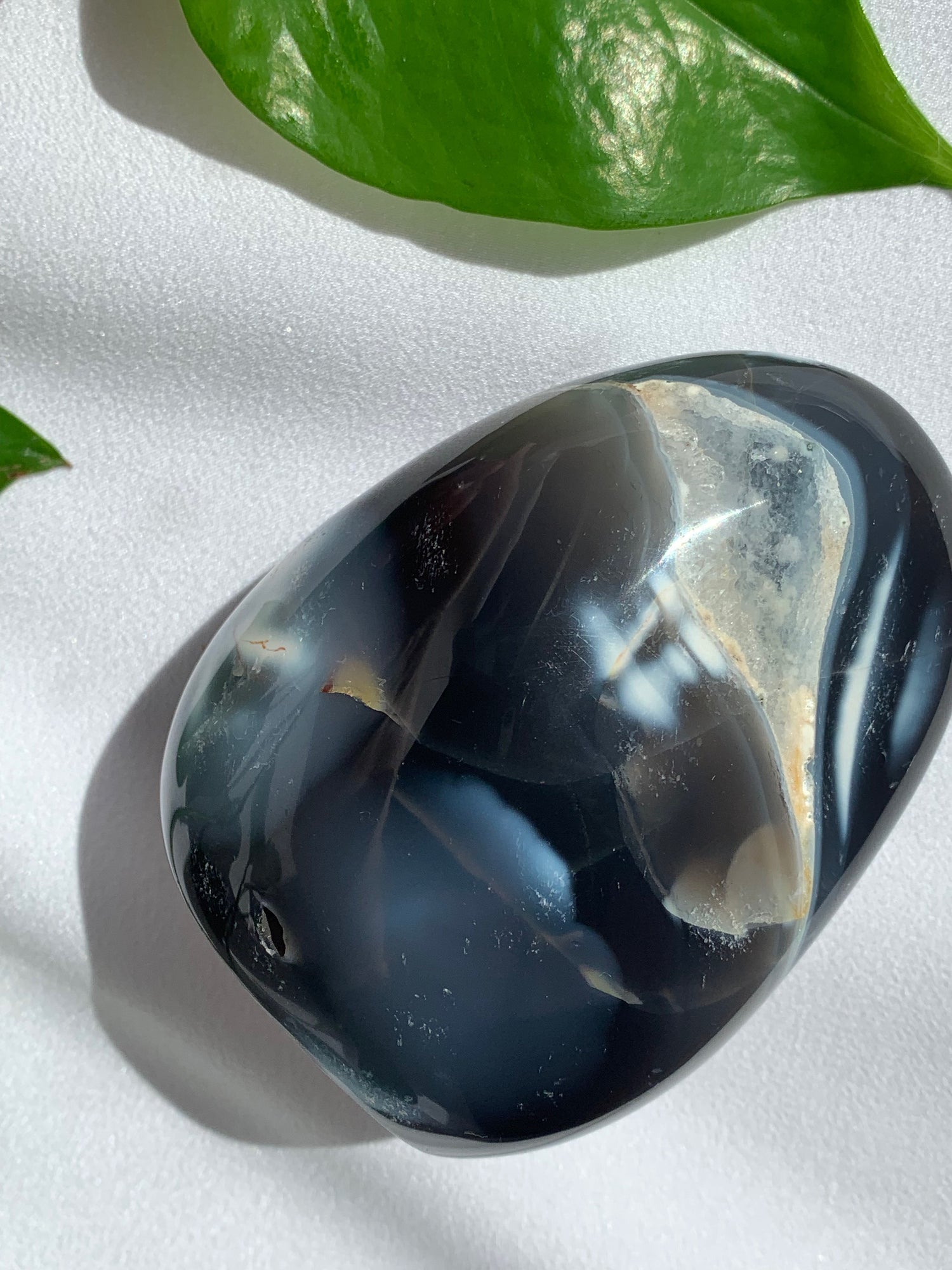 Orca agate freeform. Black opaque polished agate crystal with clear pocket of druzy quartz.